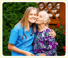 patient kissing the cheeks of a female caregiver
